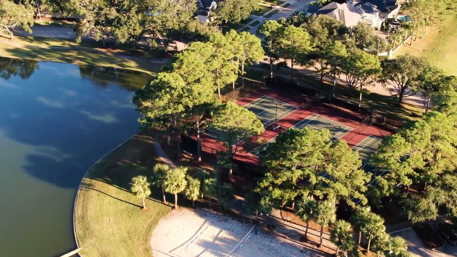 Aerial view of tennis courts and lake at Lakes on Eldridge in Houston