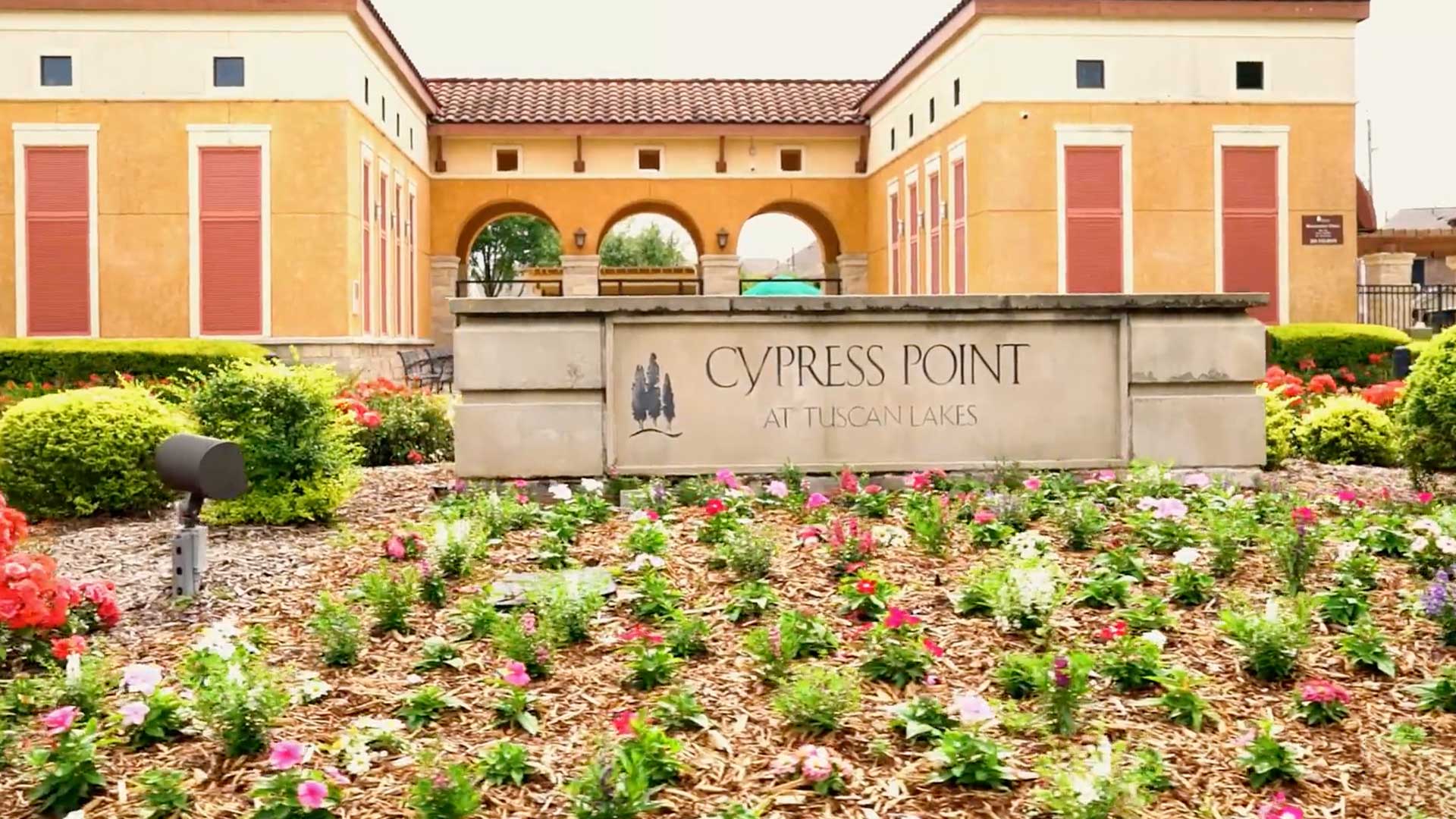 Cypress Point at Tuscan Lakes monument entrance sign with flowers