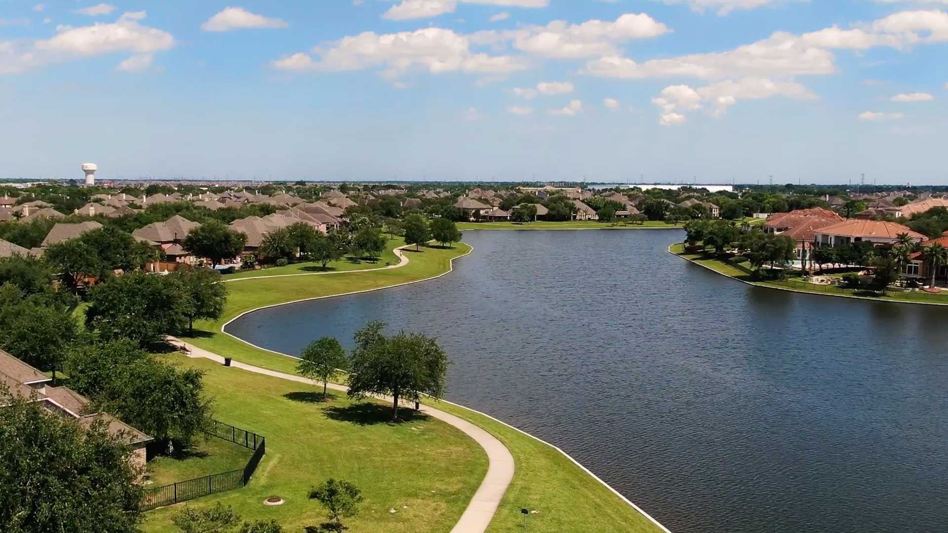 Aerial of lakefront homes and walking paths at Tuscan Lakes