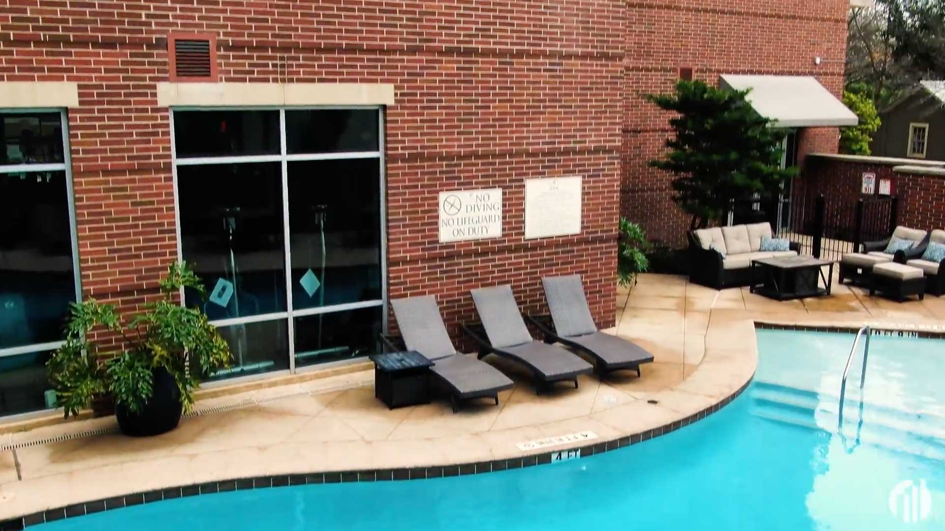 Poolside lounge seating and patio at Vidorra Condominiums