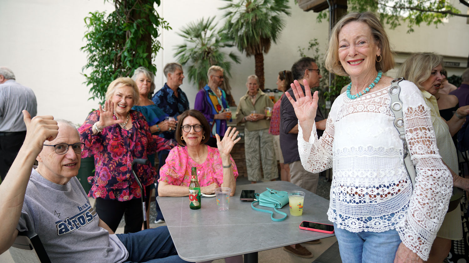 Woodway residents socializing around a courtyard table at a community event