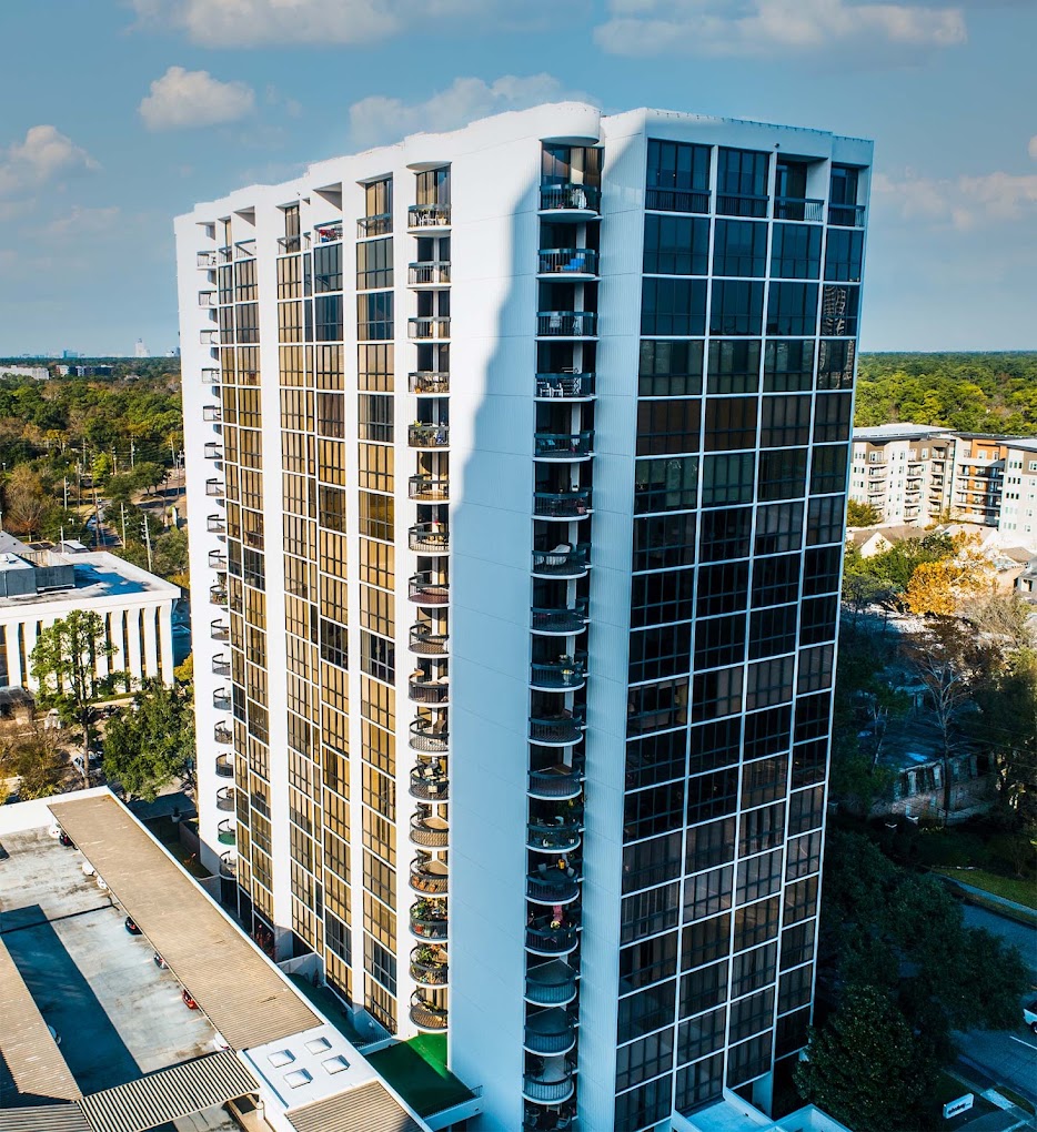 Aerial view of The Woodway Condominium high-rise tower and pool deck in Houston’s Memorial area